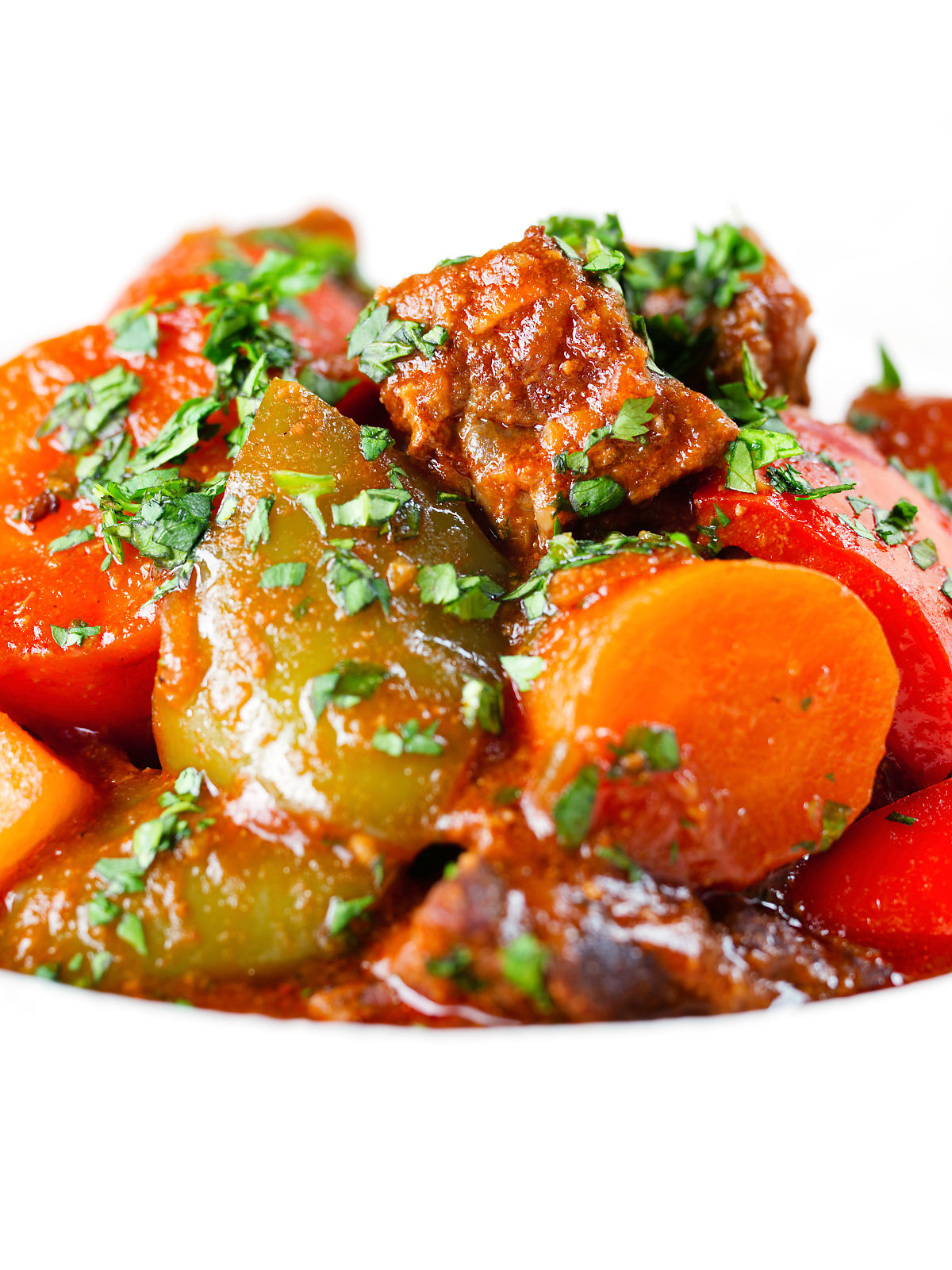 Close-up Filipino beef kaldereta (caldereta) stew garnished with coriander.