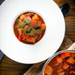 Overhed Filipino beef kaldereta (caldereta) stew garnished with coriander.