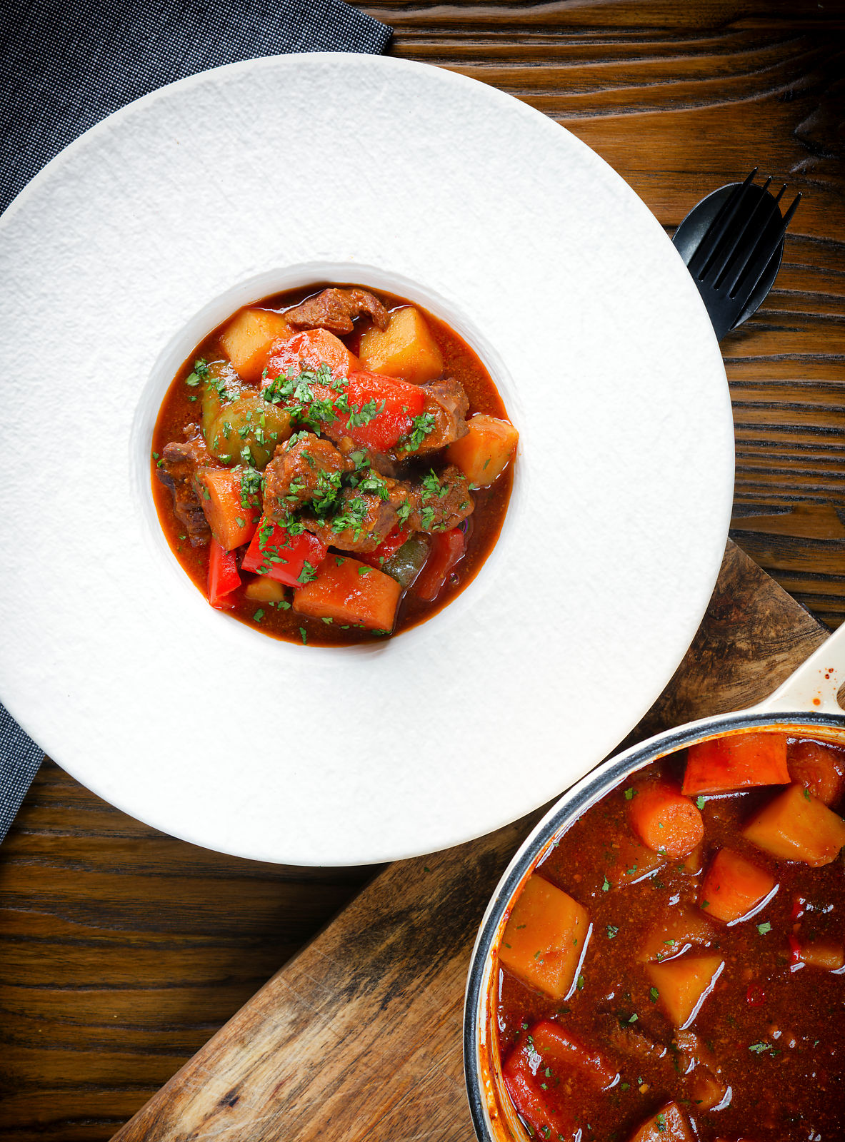 Overhed Filipino beef kaldereta (caldereta) stew garnished with coriander.
