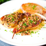 Blue cheese roasted pears with a nutty crumble and cider sauce served with a pork chop.