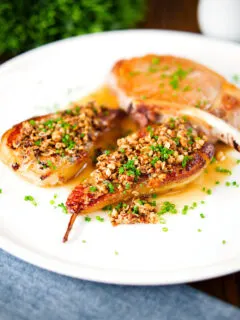 Blue cheese roasted pears with a nutty crumble and cider sauce served with a pork chop.