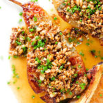 Close-up overhead blue cheese roasted pears with a nutty crumble and cider sauce.