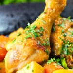 Close-up Vietnamese yellow chicken curry (ca ri ga) served with jasmine rice.