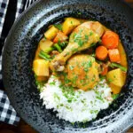 Overhead Vietnamese yellow chicken curry (ca ri ga) served with jasmine rice.