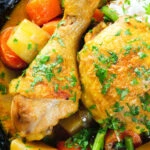 Close-up overhead Vietnamese yellow chicken curry (ca ri ga) served with jasmine rice.
