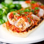 Baked chorizo and brown rice stuffed squid in tomato sauce, served on focaccia.