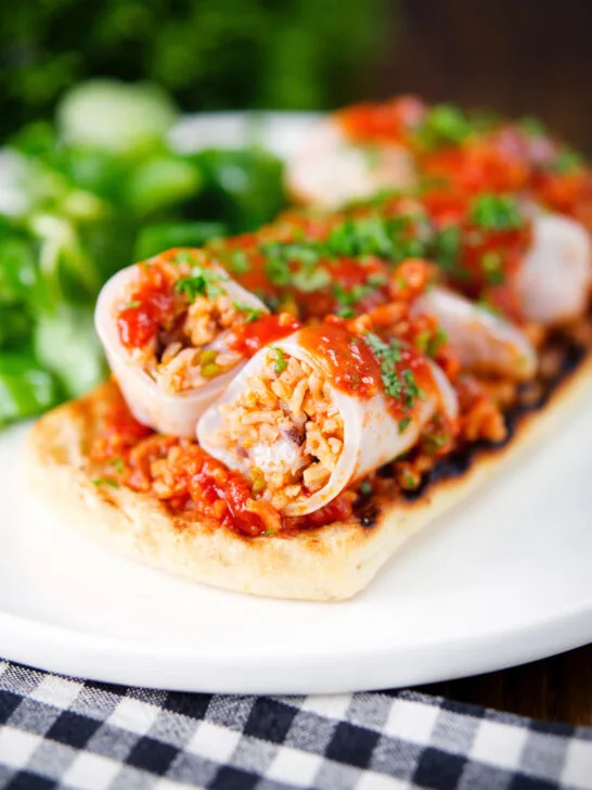 Baked chorizo and brown rice stuffed squid in tomato sauce, served on focaccia.