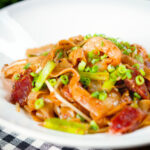 Char kway teow (flat rice noodle stir fry) with Chinese sausage and prawns.
