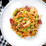 Overhead char kway teow (flat rice noodle stir fry) with Chinese sausage and prawns.
