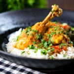 Pakistani chicken salan curry with plain rice and kachumber salad.