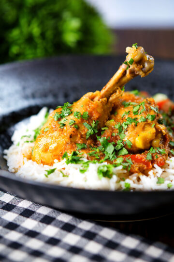 Pakistani chicken salan curry with plain rice and kachumber salad.