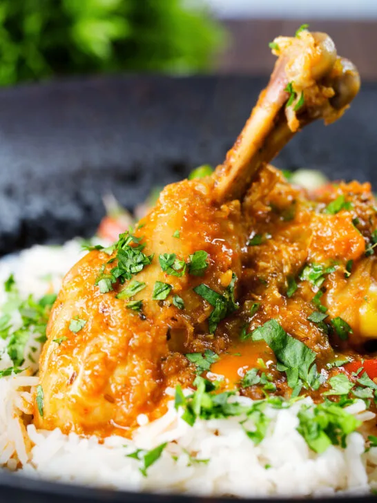 Close-up Pakistani chicken salan curry with plain rice.