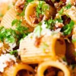 Close-up pork mince pasta ragu with balsamic vinegar, sun-dried tomatoes and sage.
