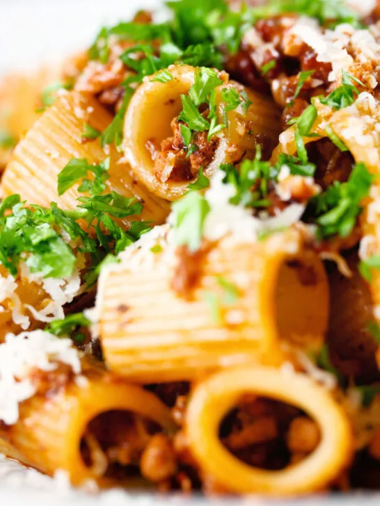 Close-up pork mince pasta ragu with balsamic vinegar, sun-dried tomatoes and sage.