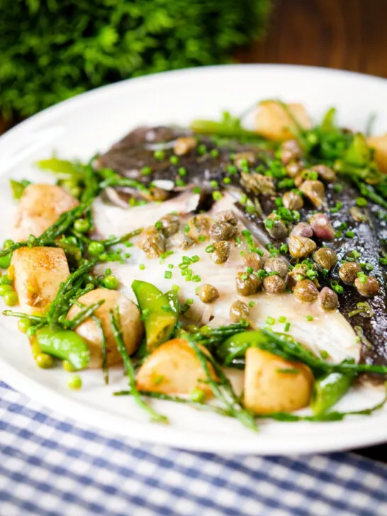 Whole roast turbot with capers, new potatoes, samphire, asparagus, sugar snap peas and garden peas.