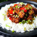 Vegan/vegetarian Szechuan tofu with peppers and red onion served with white rice.