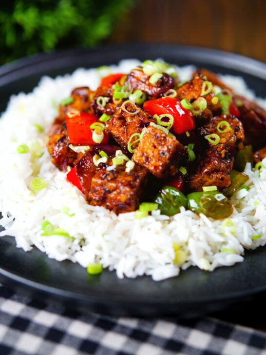 Vegan/vegetarian Szechuan tofu with peppers and red onion served with white rice.