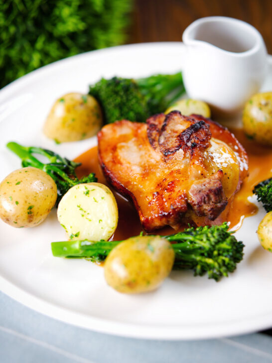 Baked apple and bacon stuffed pork chops, with cider gravy, potatoes and broccoli.