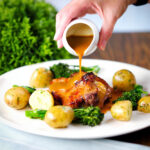 Baked sage, apple and bacon stuffed pork shoulder chops, with cider gravy, buttered potatoes and broccoli.