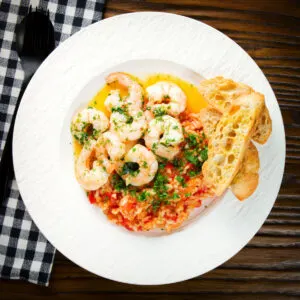 Camarao à guilho (Portuguese garlic prawns) served with tomato rice and toasted bread.