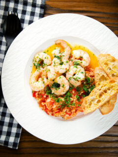 Overhead camarao à guilho (Portuguese garlic prawns) served with arroz con tomate and toasted bread.