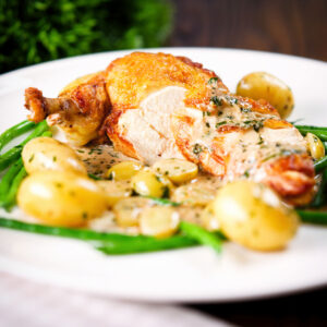 Roast chicken suprême with Veronique sauce (grapes, vermouth and tarragon), new potatoes and fine beans.
