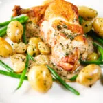 Close-up chicken with Veronique sauce (grapes, vermouth and tarragon), new potatoes and fine beans.