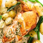 Close-up overhead chicken with Veronique sauce (grapes, vermouth and tarragon), new potatoes and fine beans.