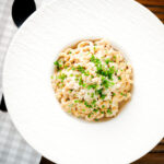 Overhead creamy Philadelphia or cream cheese pasta with garlic and chives.