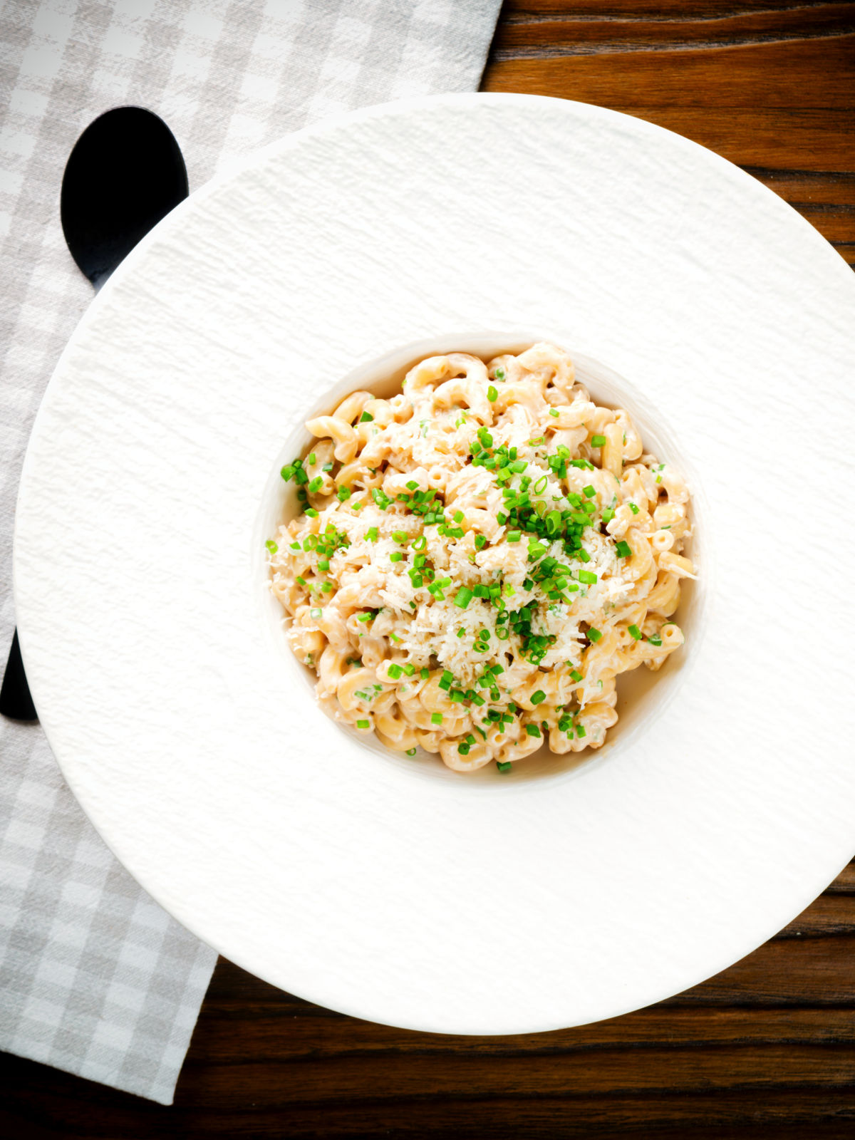Overhead creamy Philadelphia or cream cheese pasta with garlic and chives.