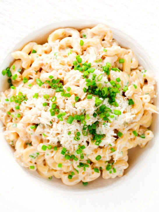 Overhead close-up creamy Philadelphia or cream cheese pasta with garlic and chives.