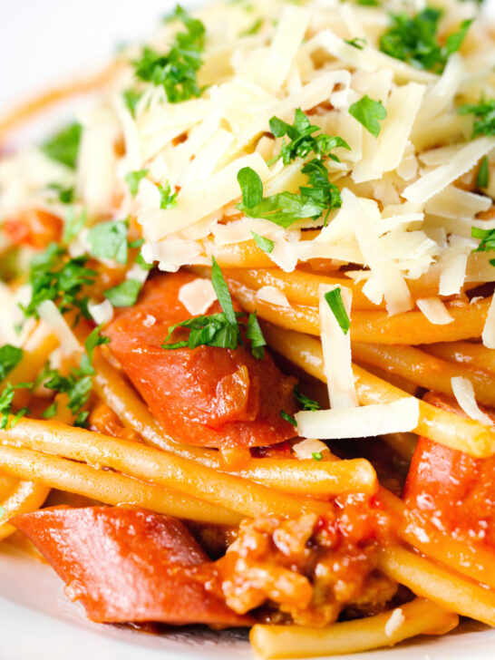 Close-up Filipino (Jollibee) spaghetti with pork, hot dog sausages and cheddar cheese.