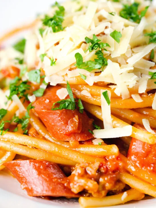 Close-up Filipino (Jollibee) spaghetti with pork, hot dog sausages and cheddar cheese.
