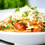 Filipino (Jollibee) sweet spaghetti with hot dog sausages, minced pork and cheddar cheese.