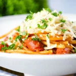 Filipino (Jollibee) sweet spaghetti with hot dog sausages, minced pork and cheddar cheese.