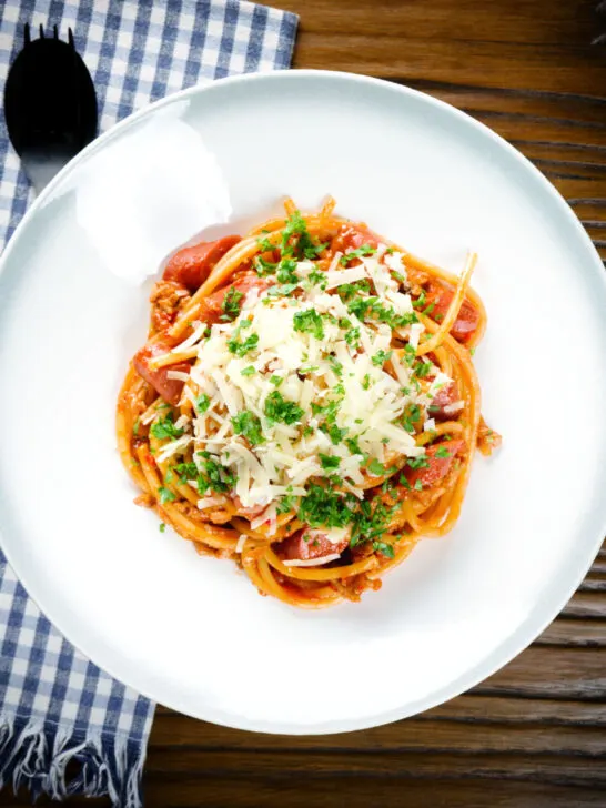 Overhead Filipino (Jollibee) spaghetti with pork, hot dog sausages and cheddar cheese.