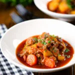 Filipino pork menudo with liver, hotdog sausages, potatoes and carrots.