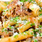 Close-up pasta alla Genovese: beef and onion ragu with ziti.