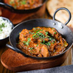 Indian (Goan) inspired pork vindaloo curry served with rice and naan bread.
