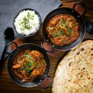 Goan-inspired pork vindaloo curry served with rice and naan bread.