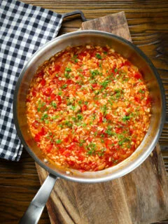 Overhead Portuguese arroz con tomate (tomato rice) side dish in its cooking pan.