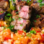 Portuguese beef espetada skewers cut open to show medium rare cook.