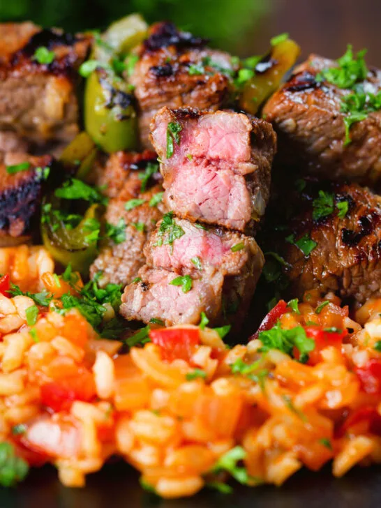 Portuguese beef espetada skewers cut open to show medium rare cook.
