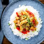 Overhead spicy squid stir fry in oyster sauce and crispy chilli oil served with white rice.