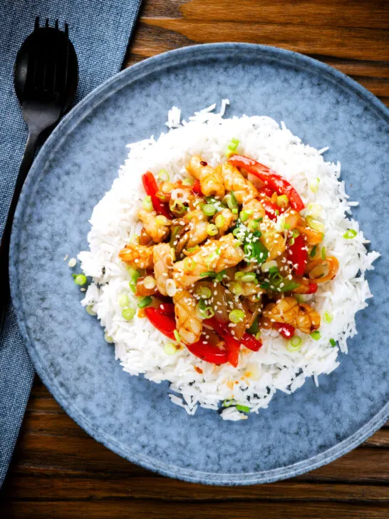 Overhead spicy squid stir fry in oyster sauce and crispy chilli oil served with white rice.
