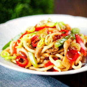 Stir fried sweet chilli chicken udon noodles with peppers and red onion.