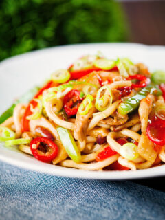 Spicy stir fried sweet chilli chicken udon noodles with peppers.