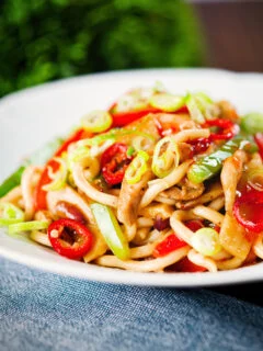 Spicy stir fried sweet chilli chicken udon noodles with peppers.