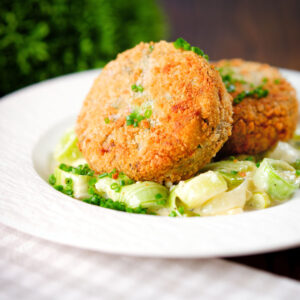 Tinned salmon, sardine and caper fish cakes served with creamed leeks.