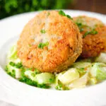 Tinned salmon and sardine fish cakes served with creamed leeks.